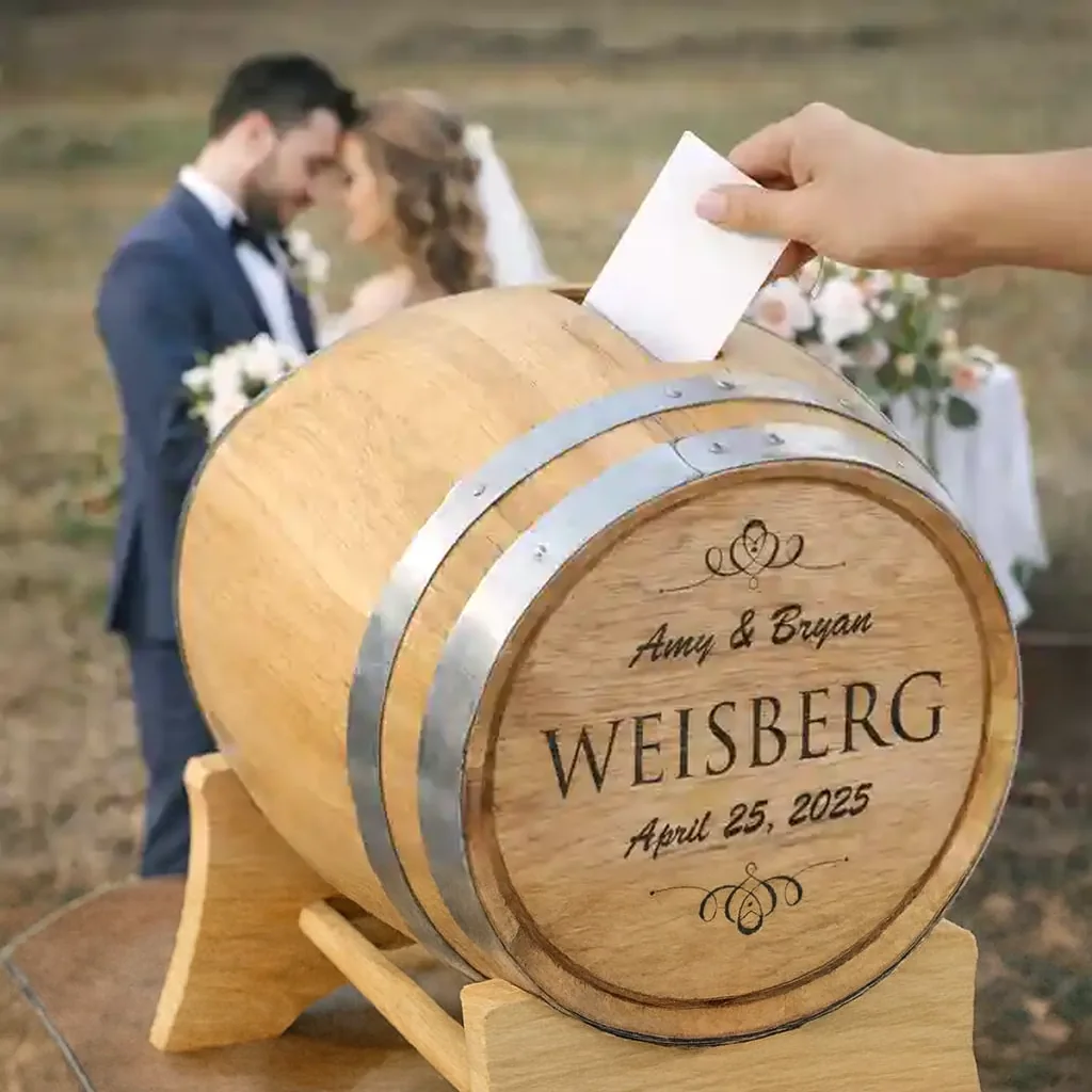 Guest dropping a card into an engraved wedding barrel